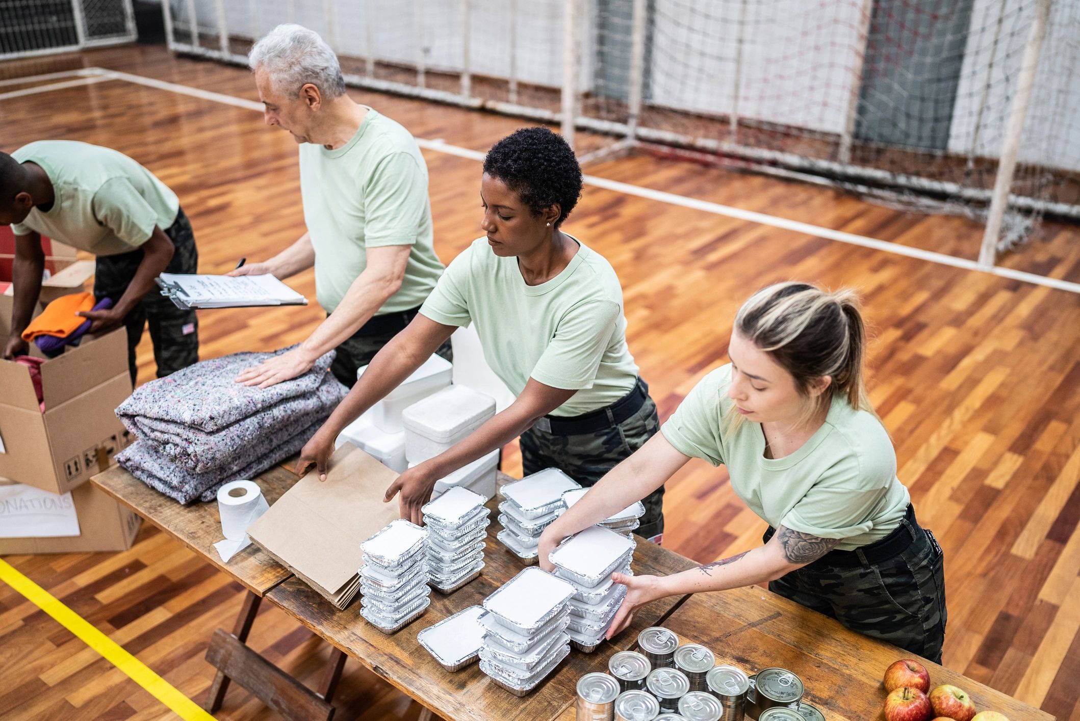 People organizing supplies in a gymnasium