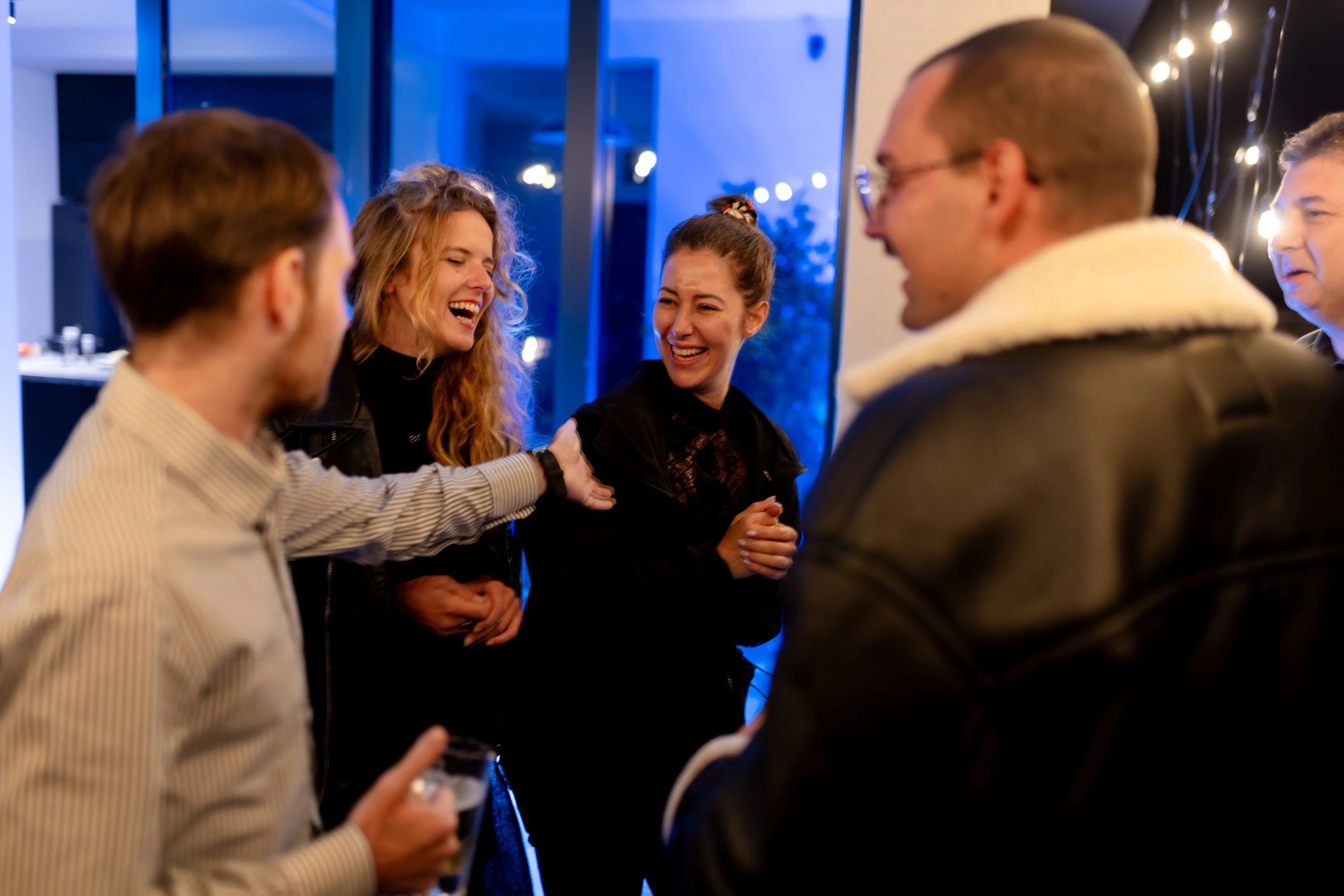 People enjoying conversation at an indoor social gathering
