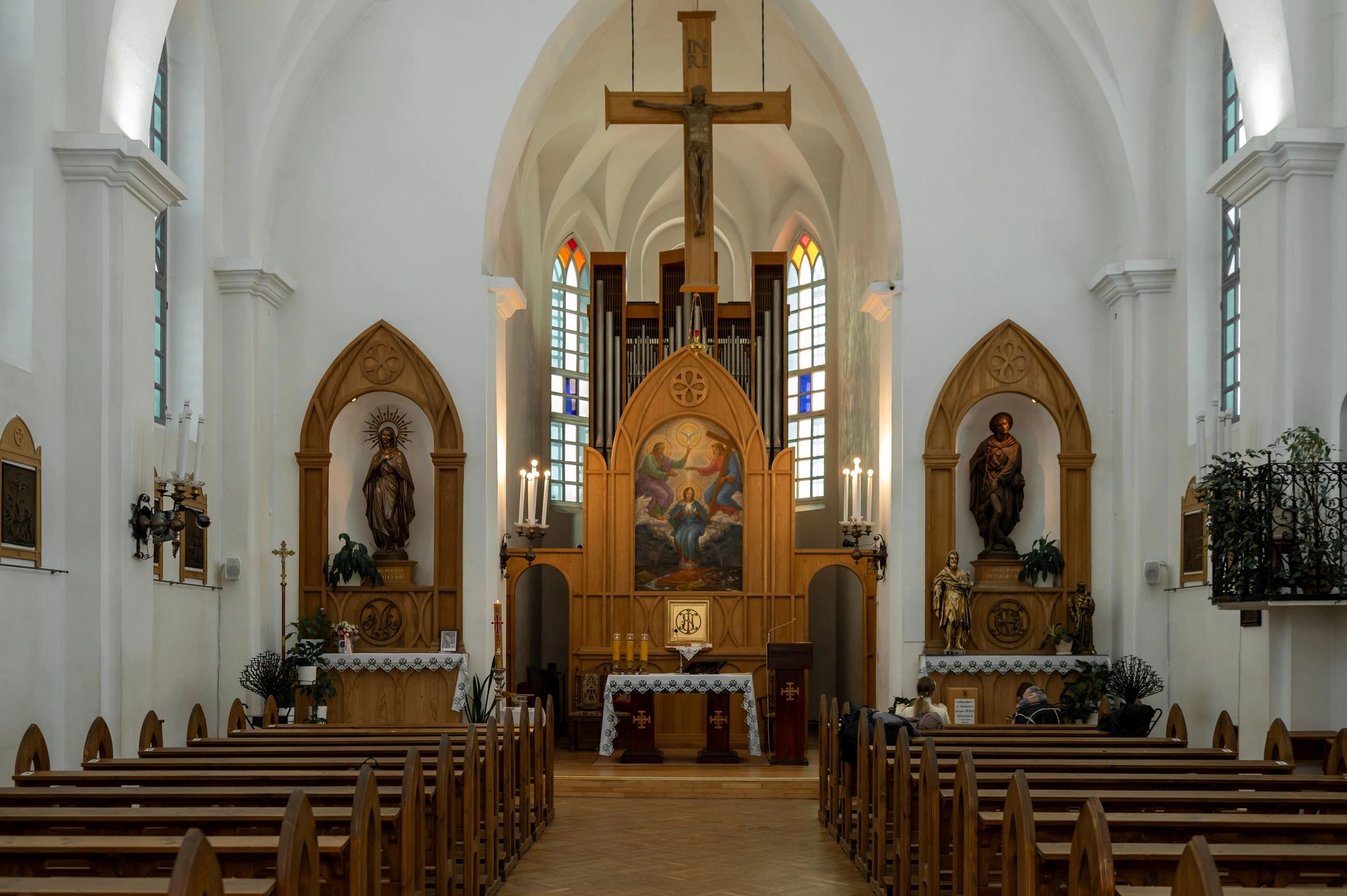 Neo-Gothic church interior with wooden pews