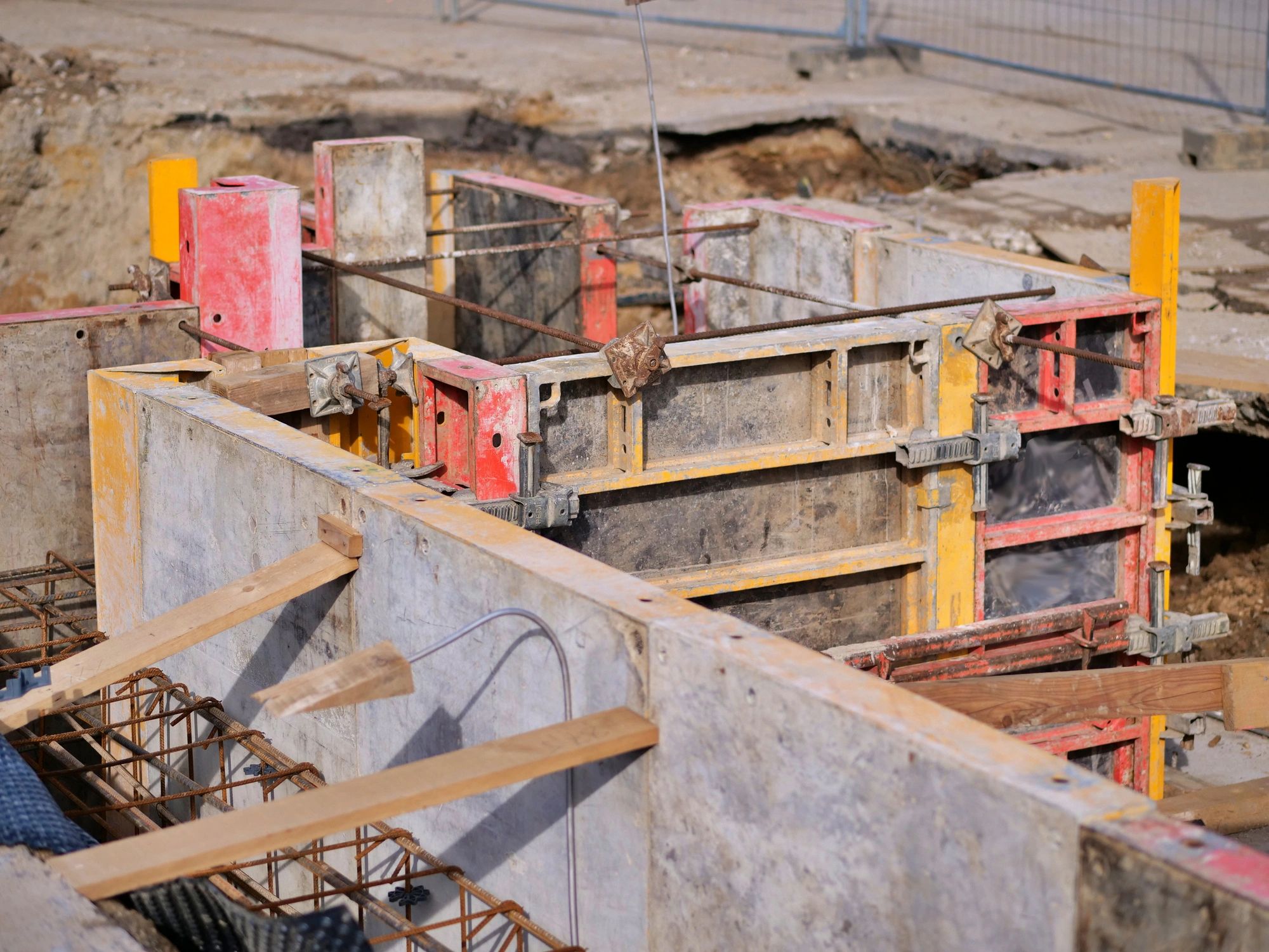 Foundation formwork and construction materials at a building site