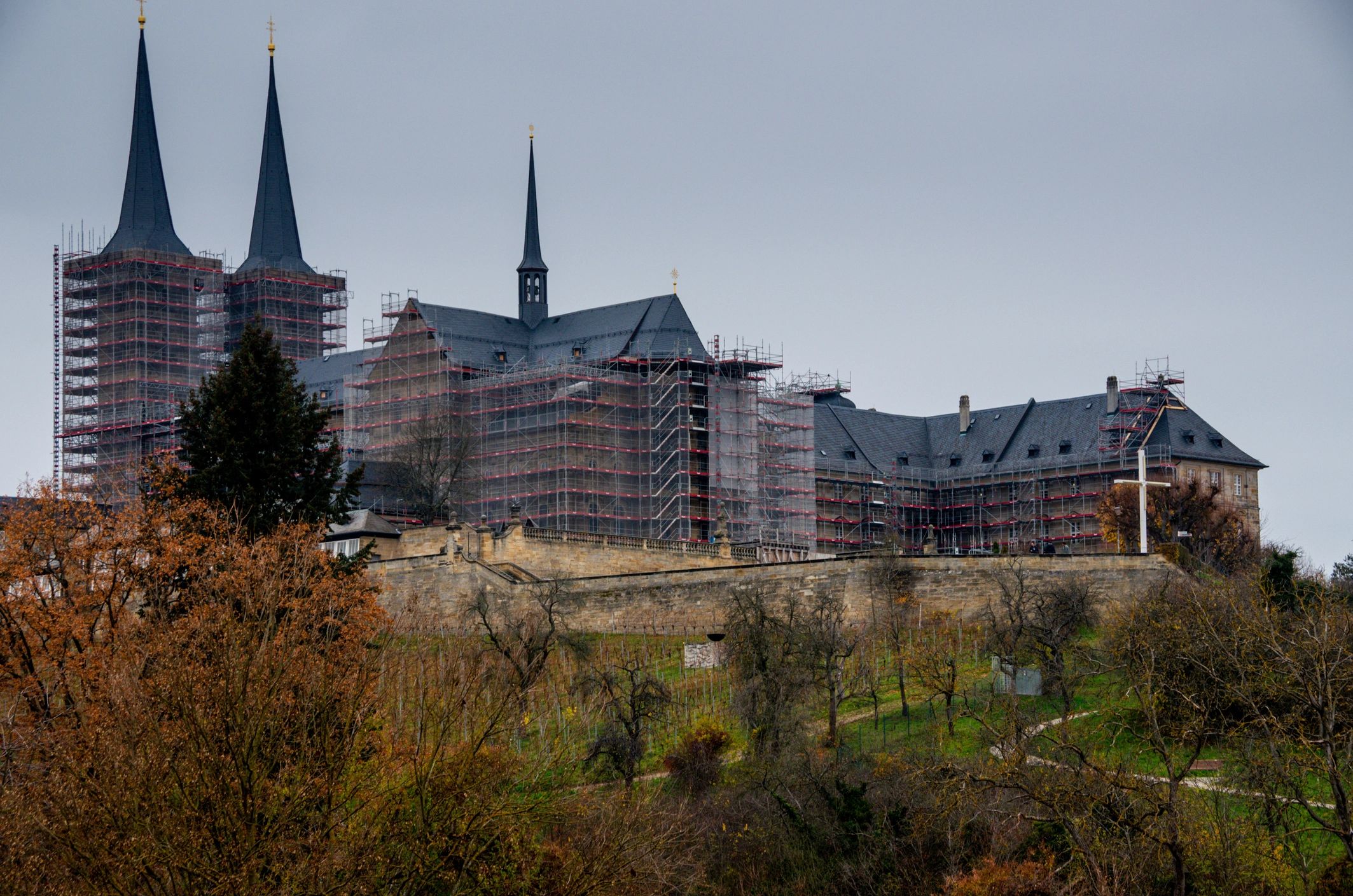 Historic monastery building under renovation with scaffolding
