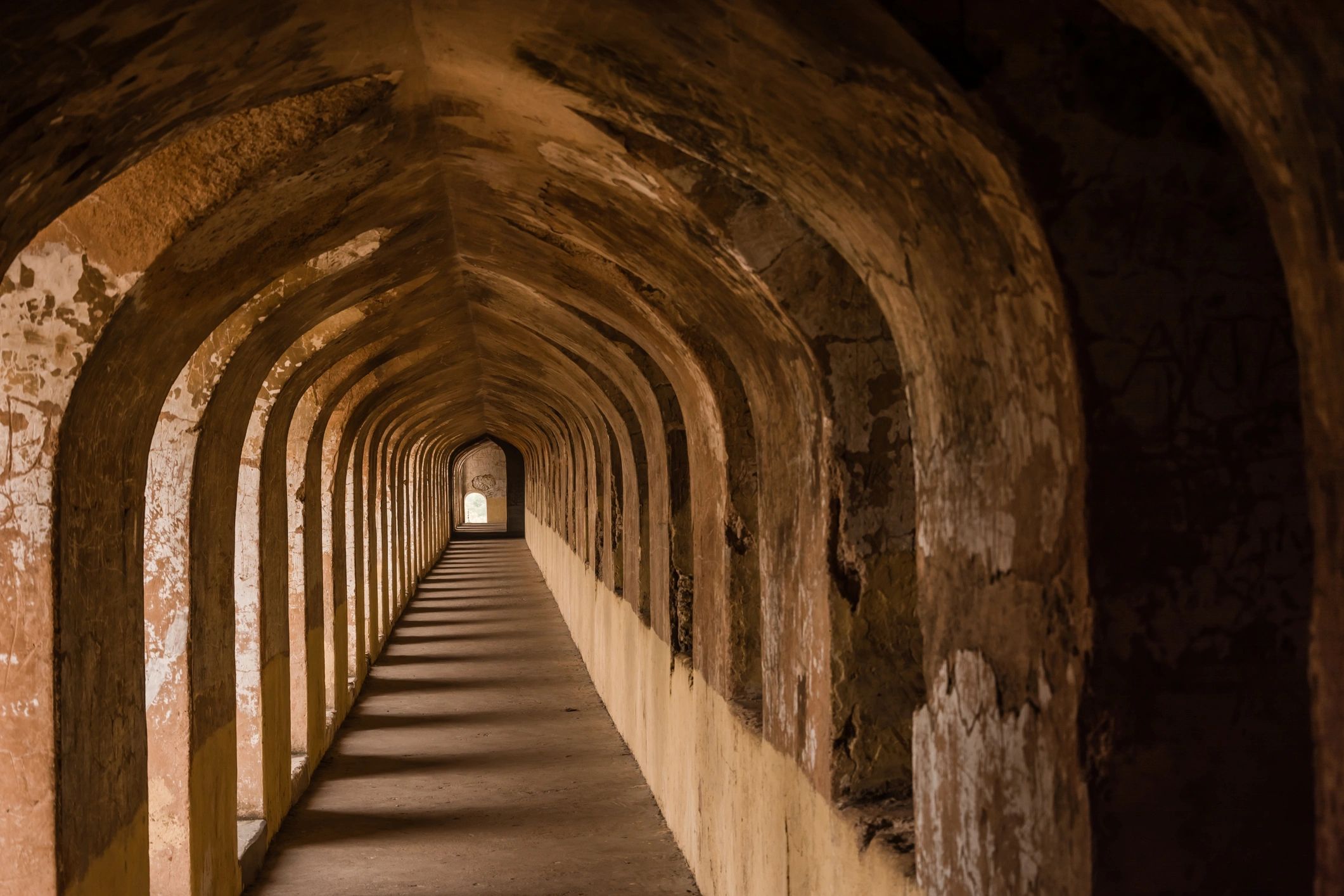 Arched interior corridor with strong perspective